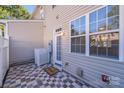 Private patio area featuring decorative tiled flooring, a white privacy fence, and access to the home at 563 Goldstaff Ln, Charlotte, NC 28273