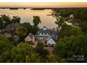 Breathtaking aerial view of lakefront home featuring lush greenery and private dock at 16921 Jetton Rd, Cornelius, NC 28031