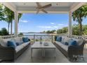 Relaxing outdoor seating on porch offers beautiful lake views and comfortable furnishings at 16921 Jetton Rd, Cornelius, NC 28031