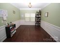 Formal dining room with green walls, wainscoting, and hardwood floors at 628 Barcroft Ln, Fort Mill, SC 29715