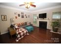 Living room with fireplace, hardwood floors, and comfy seating area at 628 Barcroft Ln, Fort Mill, SC 29715