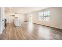 Bright living room showcasing hardwood floors and access to the backyard through sliding glass doors at 123 Dorian Pl, Troutman, NC 28166