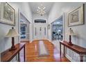 Grand foyer featuring hardwood floors, chandelier, and elegant doorway accents with natural light at 1567 Fayrene Rd, Rock Hill, SC 29732