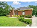 Charming brick home with manicured lawn, stone detail, covered entryway, and mature greenery at 1567 Fayrene Rd, Rock Hill, SC 29732