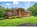 Brick home with attractive landscaping, lush green lawn, and brick entranceway on a sunny day at 1567 Fayrene Rd, Rock Hill, SC 29732