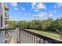 A view from a balcony overlooking a grassy field with trees and parked cars at 211 Heritage Blvd # 502, Fort Mill, SC 29715