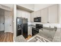 Modern kitchen with granite countertops and black appliances at 115 E Park Ave # 419, Charlotte, NC 28203