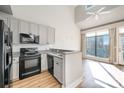 Modern kitchen with granite countertops and black appliances at 115 E Park Ave # 419, Charlotte, NC 28203
