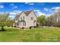 Backyard view showcasing a refreshing swimming pool and a spacious, green lawn at 500 Pearl Place Ln, York, SC 29745