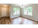 Sunlit dining area featuring hardwood floors and bright windows at 5832 Amity Springs Dr, Charlotte, NC 28212
