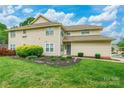 Inviting two-story home boasts a well-manicured lawn and beautiful landscaping at 5832 Amity Springs Dr, Charlotte, NC 28212
