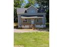 Charming home featuring a covered porch and a classic gray color scheme at 1506 7Th St, Statesville, NC 28677