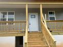 New construction home featuring a charming front porch with wood railings and gray siding at 1506 7Th St, Statesville, NC 28677