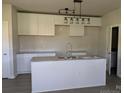 Bright kitchen with white cabinets, granite countertops, and a central island at 1506 7Th St, Statesville, NC 28677