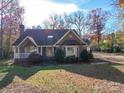 Attractive single-story brick home with a well-maintained lawn and mature trees at 909 Woodhurst Dr, Monroe, NC 28110