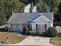 Tan house with red shutters, landscaping, and driveway at 14301 Beryl Ct, Pineville, NC 28134