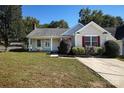 Charming single-story home with a well-maintained lawn, red shutters, and mature landscaping at 14301 Beryl Ct, Pineville, NC 28134