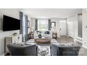 Inviting living room with stylish furnishings, a large window and a neutral color palette at 442 Serenity Cir, Cramerton, NC 28032