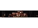 Elegant two-story brick home exterior illuminated at night with landscape lighting at 9723 Sedgefield Dr, Waxhaw, NC 28173