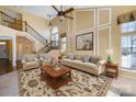 Spacious living room with high ceilings, a fireplace, and large windows at 1001 Hatton Ter, Fort Mill, SC 29707