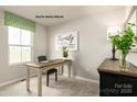 Home office with wooden desk, chair, and decorative elements at 147 Basildon St # 1007, Lancaster, SC 29720