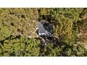 House nestled in a wooded area, aerial view at 1473 Polk Ford Rd, Stanfield, NC 28163