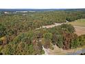 Aerial lot view showing a wooded area and nearby road at 1473 Polk Ford Rd, Stanfield, NC 28163