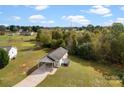 Aerial view of a single-story house with carport surrounded by lush greenery at 301 Walkers Ridge Dr, Shelby, NC 28152