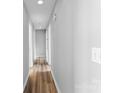 Long hallway with light grey walls and wood-look flooring at 301 Walkers Ridge Dr, Shelby, NC 28152