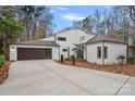 Modern white house with brown garage door and landscaped yard at 3216 High Ridge Rd, Charlotte, NC 28270