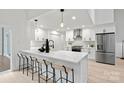 Modern white kitchen with stainless steel appliances and large island at 3216 High Ridge Rd, Charlotte, NC 28270