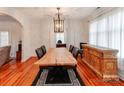 Elegant dining room featuring a custom wood table, hardwood floors, and designer lighting, perfect for entertaining and Gathering meals at 501 River Oaks Ln, Charlotte, NC 28226