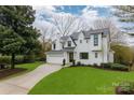 Beautiful two-story home with a lush green lawn and a paved driveway leading to the garage at 501 River Oaks Ln, Charlotte, NC 28226