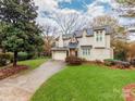 Beautiful two-story home with lush lawn, mature trees, and a curved driveway at 501 River Oaks Ln, Charlotte, NC 28226