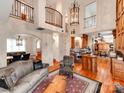 Inviting living room with hardwood floors, rustic decor, and abundant natural light from the adjacent dining room at 501 River Oaks Ln, Charlotte, NC 28226