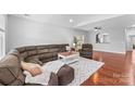 Spacious living room featuring a large sectional sofa, hardwood floors, and ample natural light at 3157 Delaware Dr, Denver, NC 28037