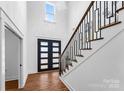 Bright entryway with double doors, hardwood floors, and a modern staircase at 8508 Tirzah Church Rd, Waxhaw, NC 28173