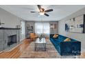 Bright living room featuring a decorative fireplace, hardwood floors, and stylish furniture at 508 Deese St, Monroe, NC 28112