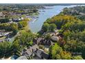 Aerial view showcasing a beautiful home on a waterfront lot with a private dock and pool at 18528 Nantz Rd, Cornelius, NC 28031