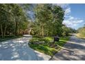 A brick home with a long driveway leading to the house and a mailbox with the house number on a green lawn at 7029 Pebble Bay Dr, Denver, NC 28037