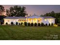 Well-manicured lawn and landscape of a single-story home with a covered entrance at dusk at 796 Cornelius Rd, Mooresville, NC 28117