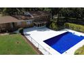 Aerial view of backyard with a pool, patio, manicured lawn, and a fenced yard, perfect for outdoor enjoyment at 809 23Rd E St, Newton, NC 28658