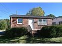 Inviting brick home featuring manicured shrubbery and a bright white front door at 125 S Ervin Ave, Newton, NC 28658