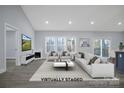 Virtually staged living room with fireplace and large windows at 7066 Sparrow Ln, Vale, NC 28168