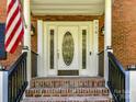 Brick front entrance with a white door and black railings at 316 Carter Rd, Monroe, NC 28110