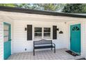 Quaint front porch with teal door, black shutters, and a bench at 1378 8Th Nw St, Hickory, NC 28601