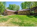 Stone and wood exterior, two-car garage, and a landscaped yard at 315 Camelot Dr, Salisbury, NC 28144