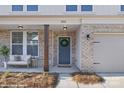 Charming front porch features a cozy sitting area and stylish brick accents at 48 Sherwood Nw Ct # Sw48, Concord, NC 28027