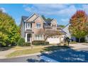 A beautiful two-story home with stone accents, lush landscaping, and a three-car garage at 507 Quicksilver Trl, Fort Mill, SC 29708