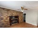 Living room with brick fireplace and hardwood floors at 807 Phillips Dr, Kings Mountain, NC 28086